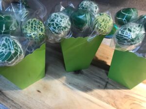 Green drizzled cake pops